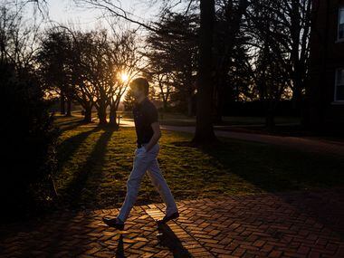 As the sun descends, a student make his way to the dining hall for dinner at Woodberry...