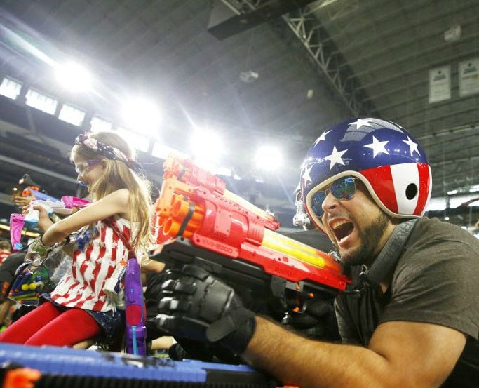 Oscar Marroquin fires a Nerf gun during Jared's Epic Nerf Battle 2 at AT&T Stadium. 