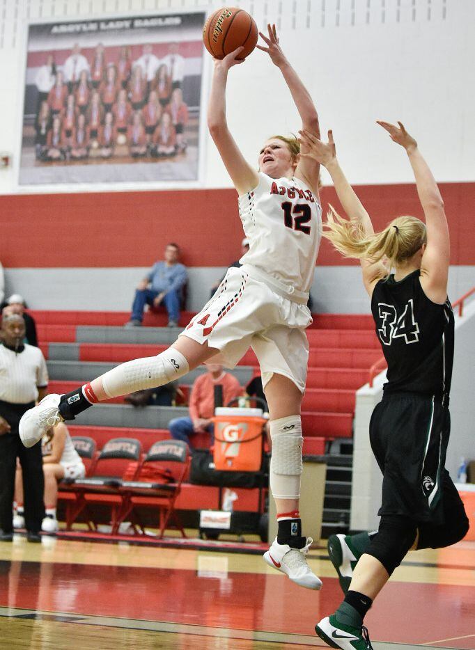 Argyle senior forward Vivian Gray (12) shoots a jump shot and scores, while being defended...