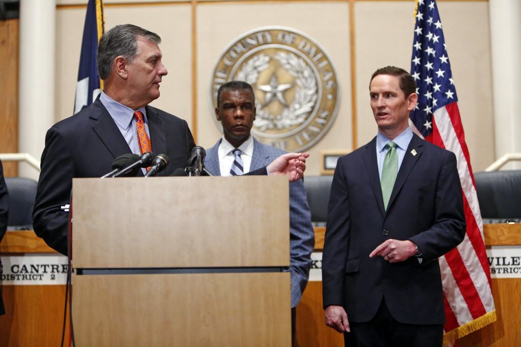 County Judge Clay Jenkins (right) and Mayor Mike Rawlings talk during a news conference about Ebola at the County Commissioners Court on Oct. 20, 2014.