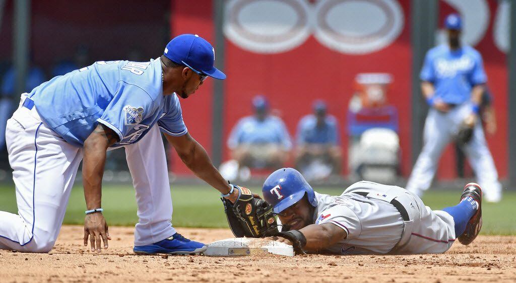 Texas Rangers' Delino DeShields steals second, sliding past the base and back on before the...