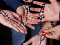 Liegea Lopez’s children hold rosaries with a photo of her in Wylie, Texas, Wednesday, Feb....