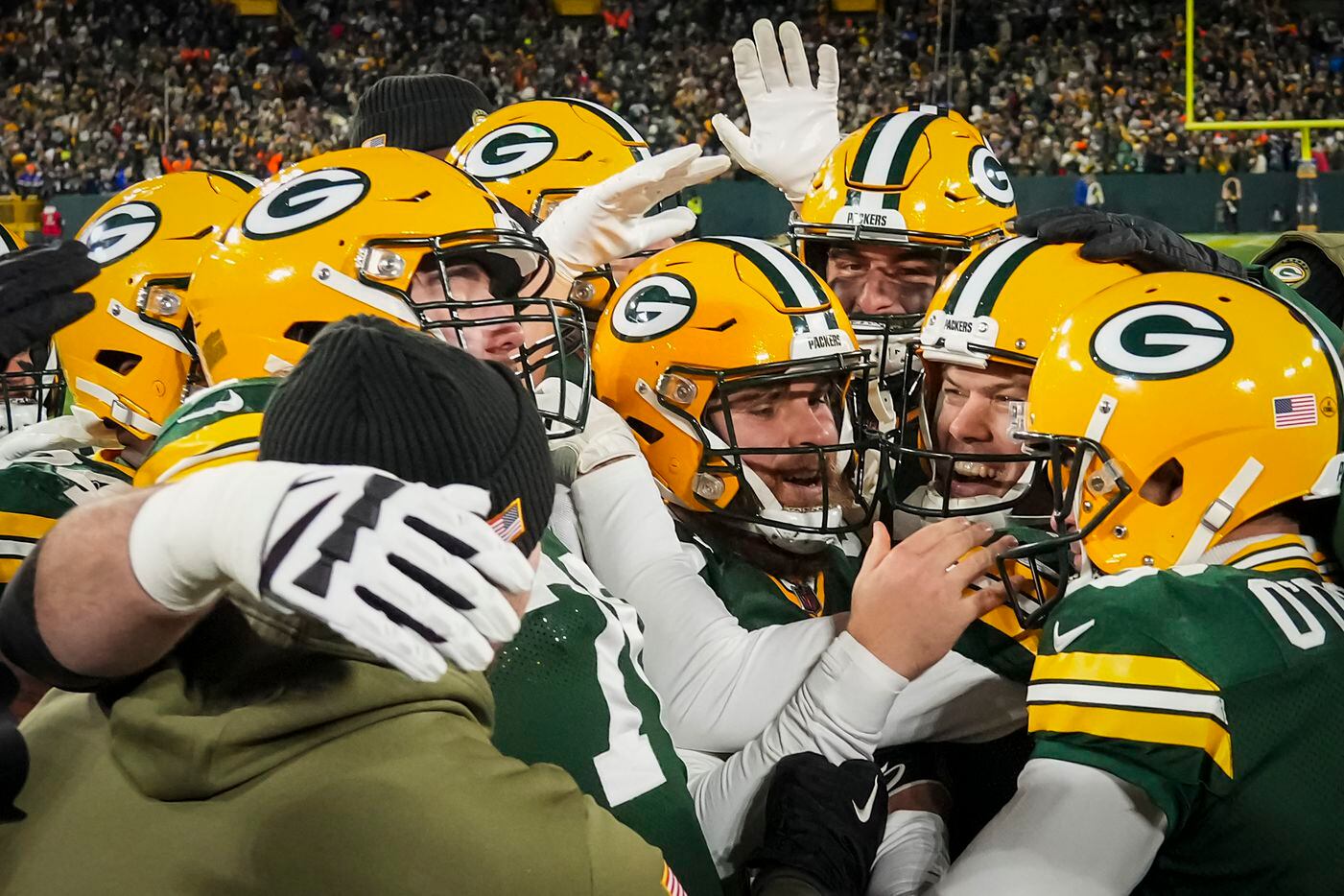 Green Bay Packers place kicker Mason Crosby (facing at right) celebrates with teammates...