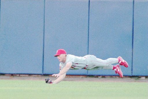 Texas Ranger left fielder Rusty Greer makes a diving  catch of a ball, robbing Milwaukee Brewer John Jaha of a hit in  the first inning with a runner on base. The Rangers went on to  win 7-4, Tuesday, May 31, 1994, in Milwaukee 