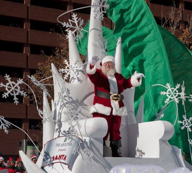 Santa rides on a float in a holiday parade in downtown Dallas.
