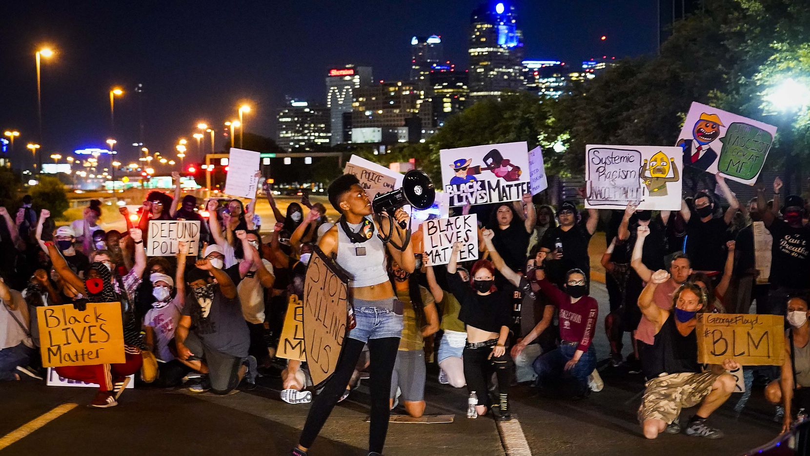 Demonstrators block traffic on the southbound US-75 Central Expressway service road at...