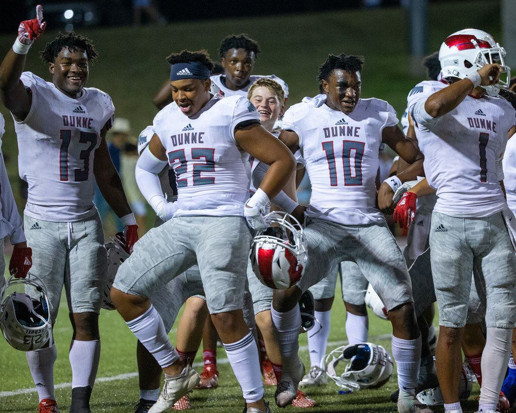 Bishop Dunne players, (from left) Josh Emmanuel, Sam Strong, Alex Orji, and Simeon Evans celebrate their win against All Saints' Episcopal School at Young Field McNair Stadium in Fort Worth, Texas, on Friday, Sep. 27, 2019. (Lynda M. Gonzalez/The Dallas Morning News)