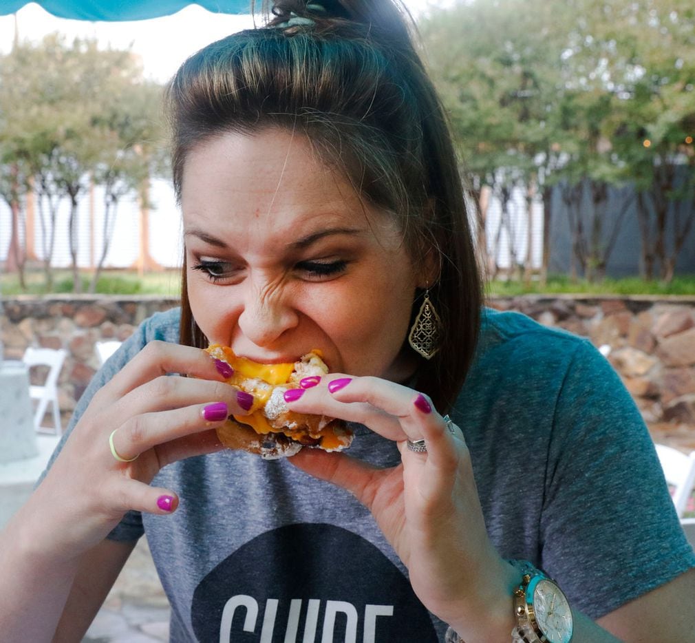 Sarah Blaskovich of The Dallas Morning News GuideLive team samples the funnel Cake Bacon Queso Burger on Friday, September 29, 2017. (David Woo/The Dallas Morning News)

 







