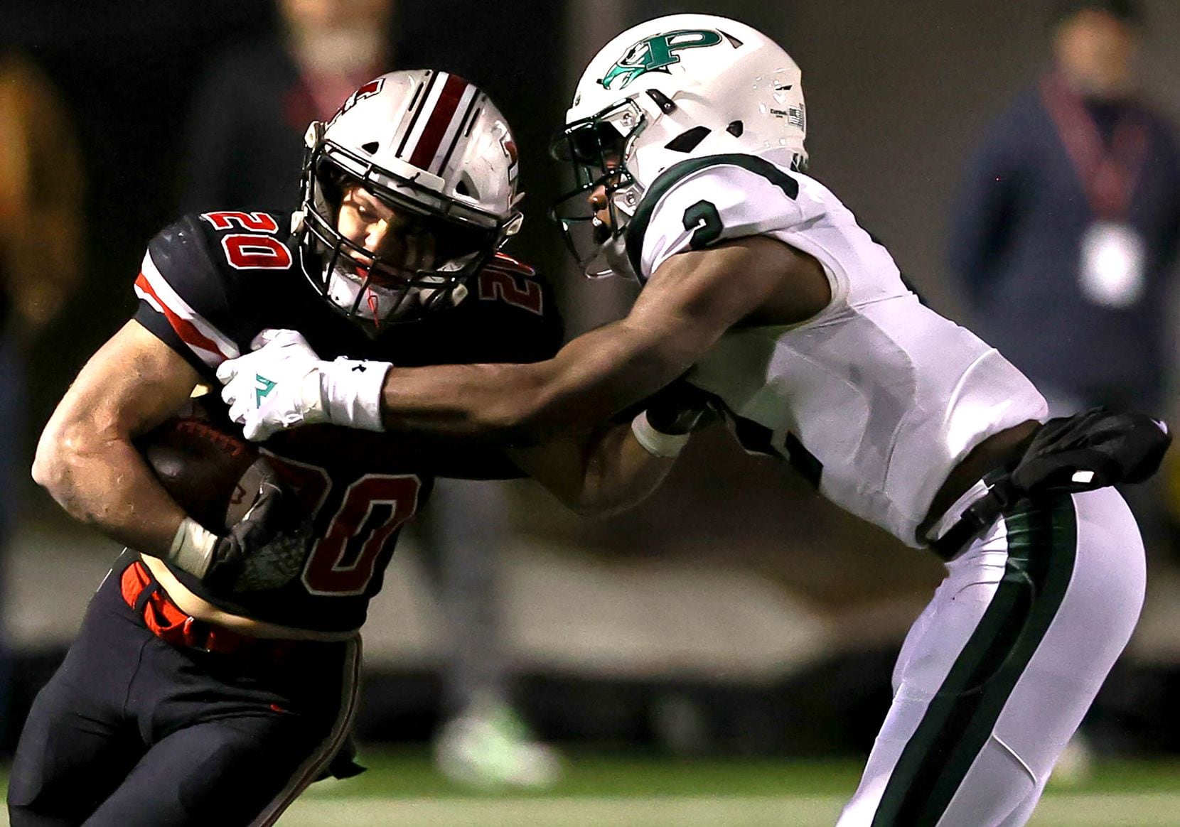 Flower Mound Marcus running back Walker Wells (20) is stopped for a short gain by Prosper...
