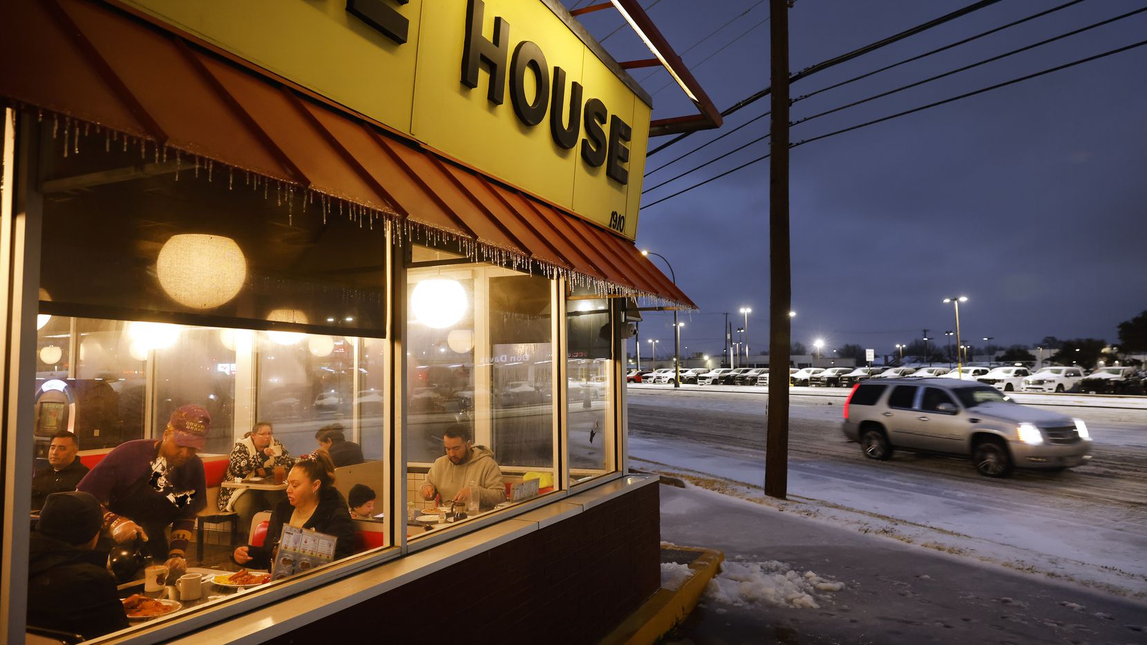 Jimmie Sloan pours a hot cup of coffee for diners keeping warm inside a Waffle House on N....