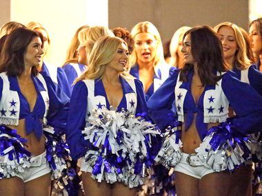 The Dallas Cowboys Cheerleaders wait in a doorway underneath the stands to take the field...