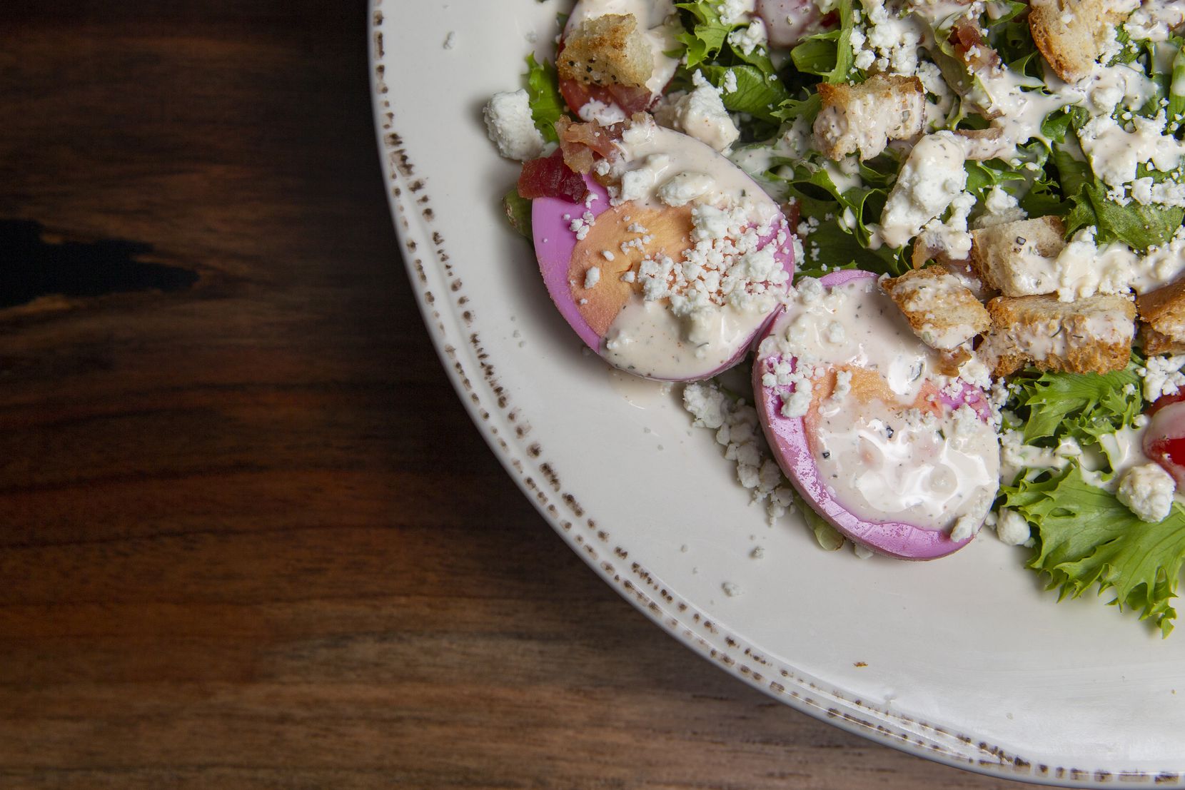 Purple pickled eggs for TCU are served with the Cobb salad as a way to honor owner Maurice Ahern's late son Micah and his devotion to the baseball team at Grounds & Gold Coffee Co.