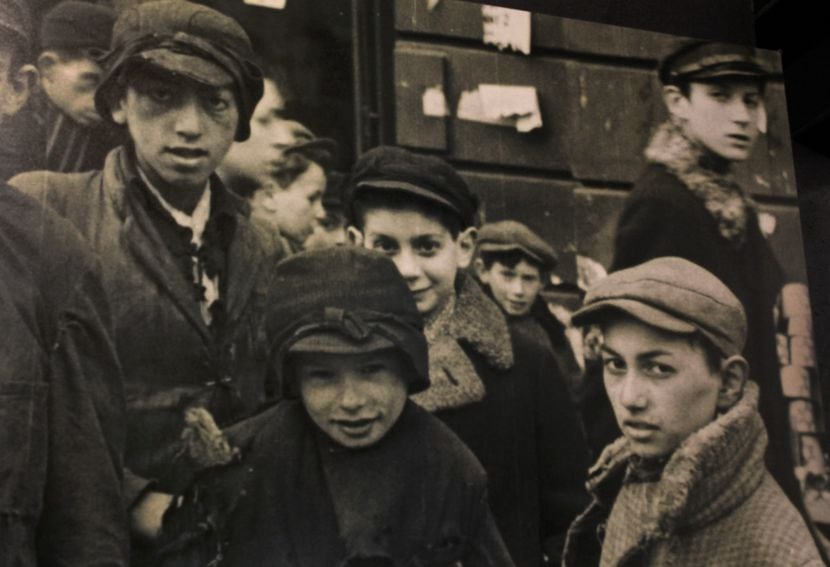 Glauben (center, partially obscured) stands with other boys in the Warsaw Ghetto prior to...