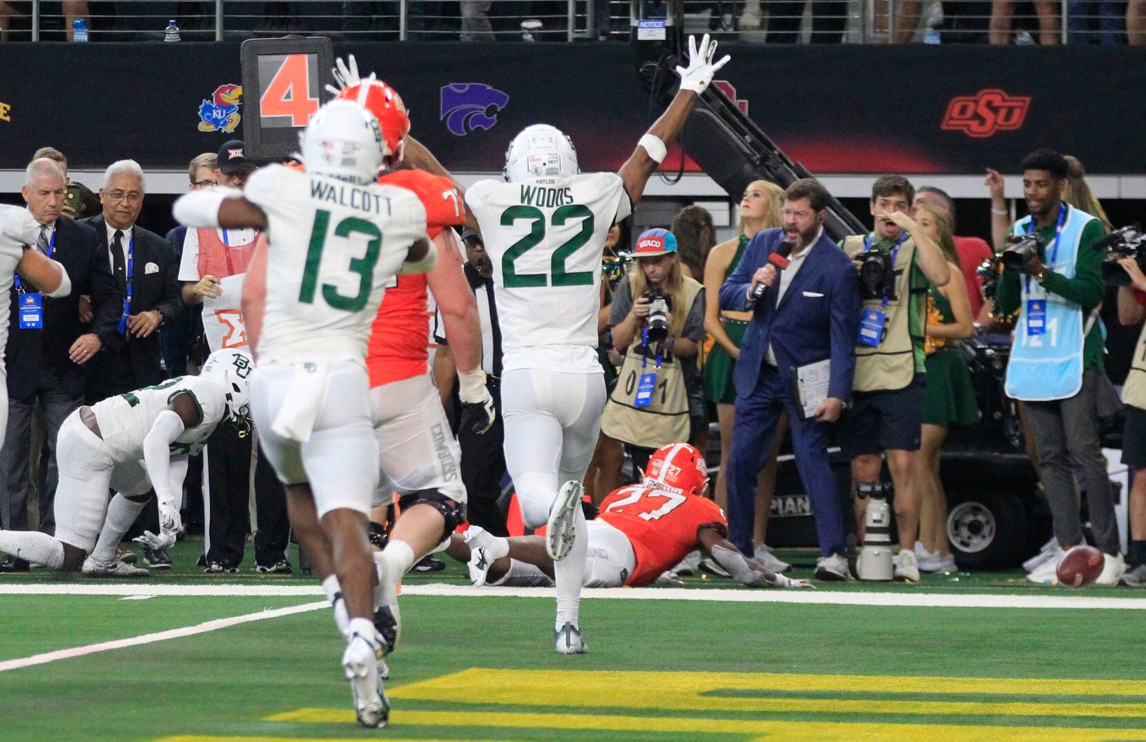 The football rolls away, and Baylor Bears safety JT Woods (22) celebrates, as Oklahoma State Cowboys running back Dezmon Jackson, on ground, fails to get into the end zone on fourth at the end of the game in the Big 12 Championship football game at AT&T Stadium in Arlington on Saturday, December 4, 2021. Baylor won 21-16. (John F. Rhodes / Special Contributor)