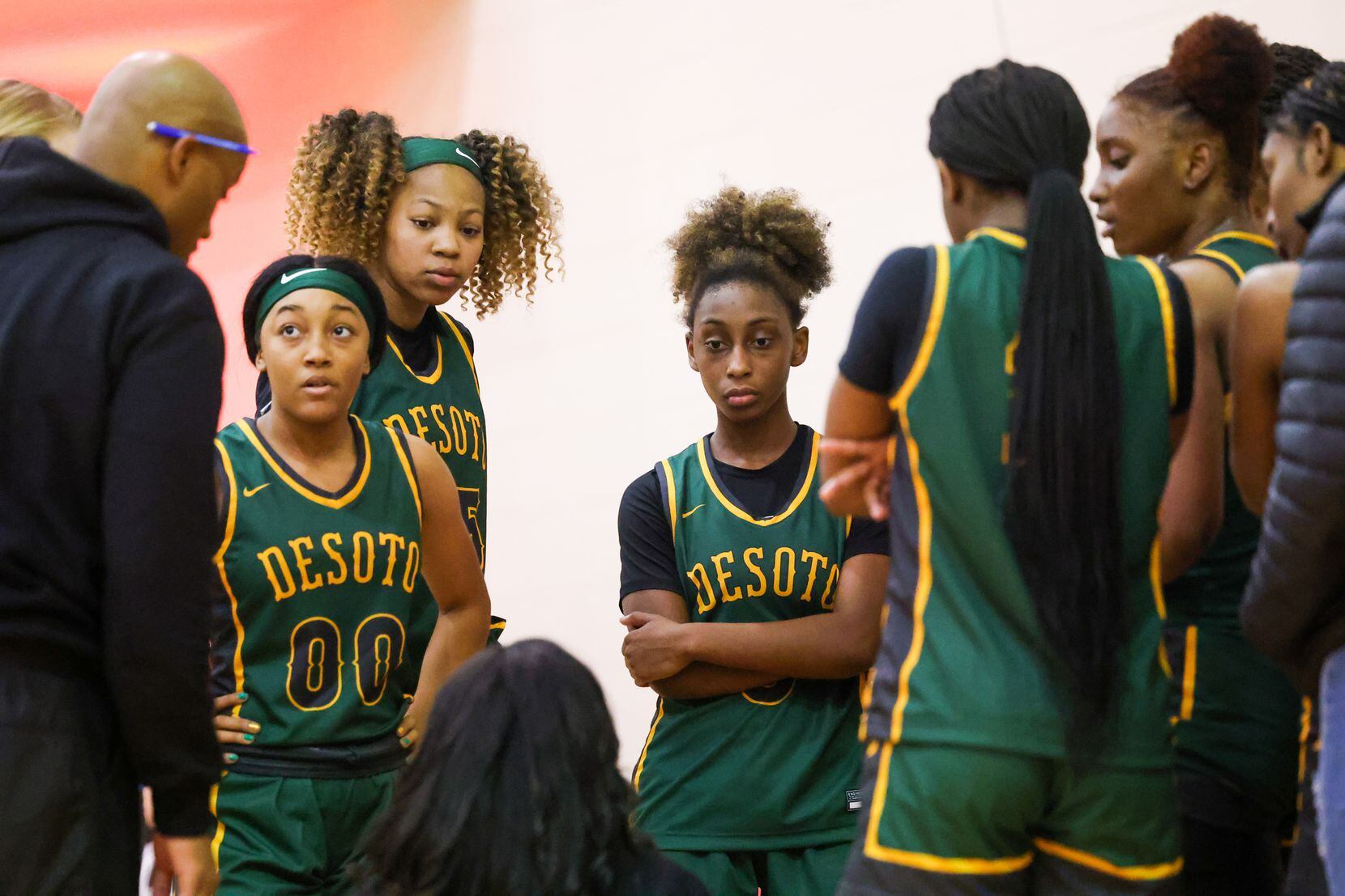 DeSoto girls basketball players circle up for a word from coaches during a time out in the...