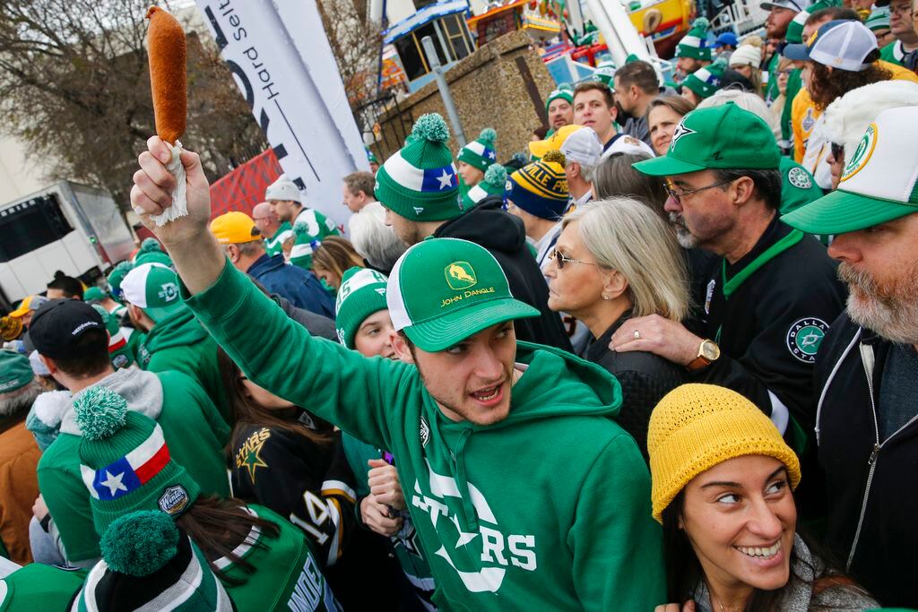 A Dallas Stars fan protects his corn dogs as the crowd slowly works their way to the stadium...