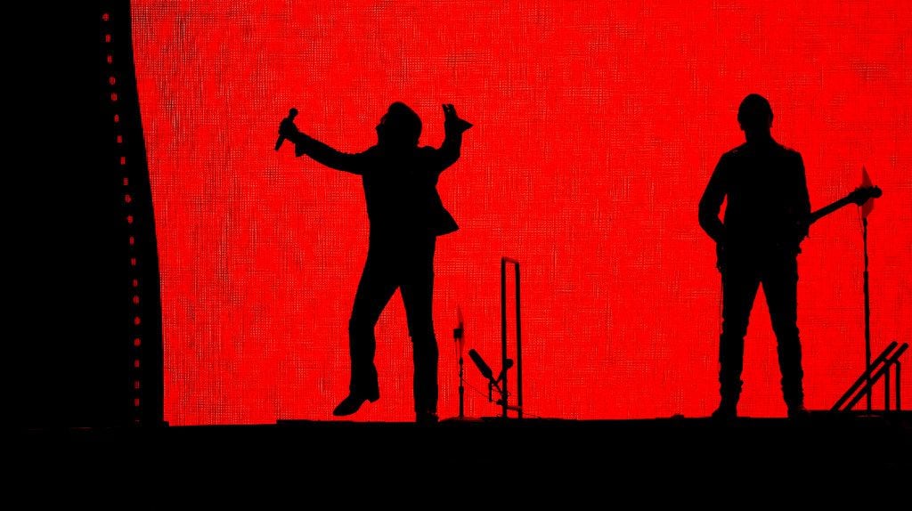 Bono (left) and the Edge of U2 perform on stage at AT&T Stadium in Arlington, Texas, Friday,...
