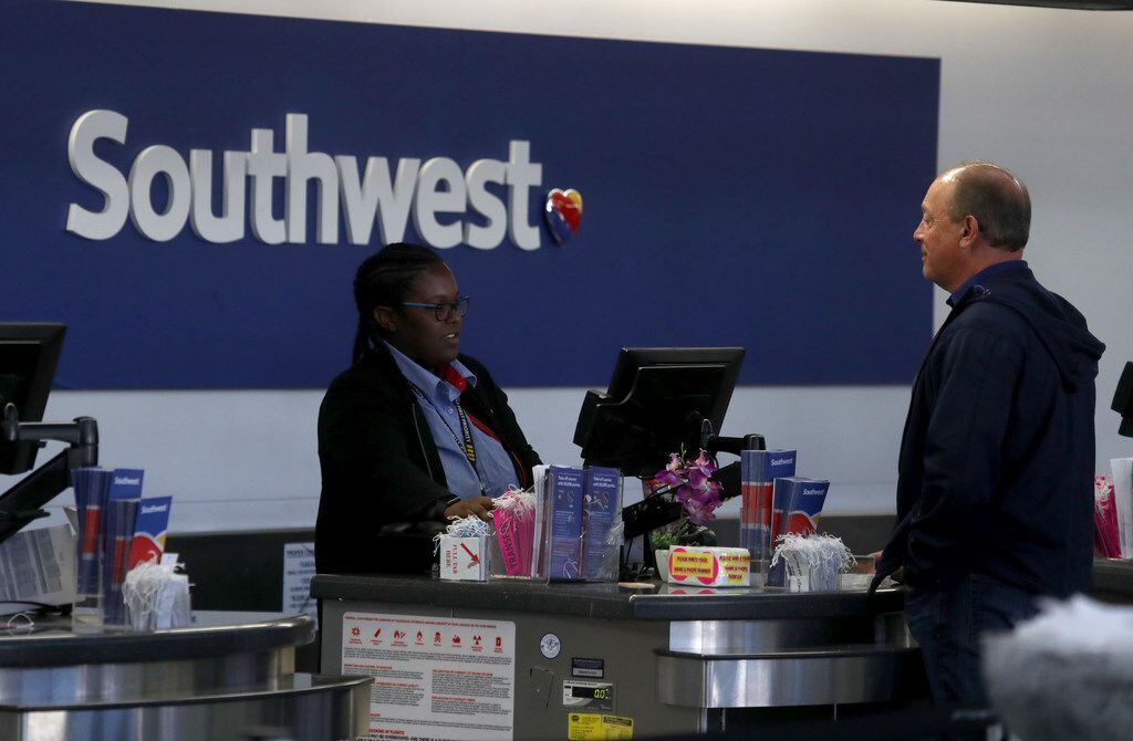 A Southwest Airlines worker helps a customer at San Francisco International Airport.