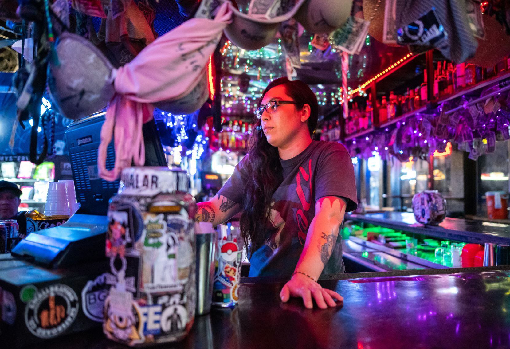 Bartender Aliyah Dominguez, 27, controls a electronic cash register while working a shift at...
