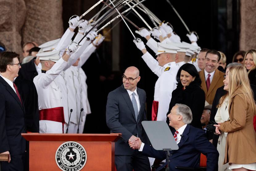 House Speaker Dennis Bonnen (center) congratulates Gov. Greg Abbott and Texas Lt. Gov. Dan...