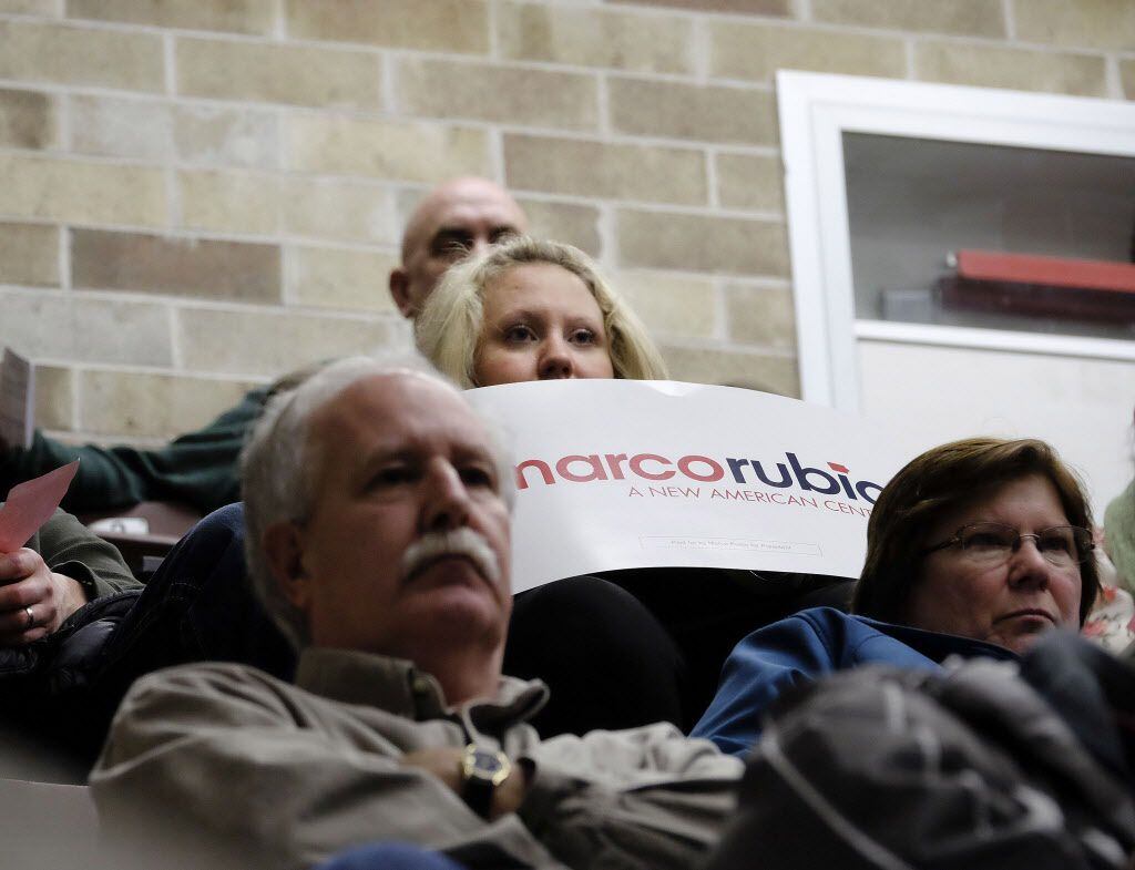 Bethany Nielsen holds her Marco Rubio sign as various candidate supporters make their pitch...