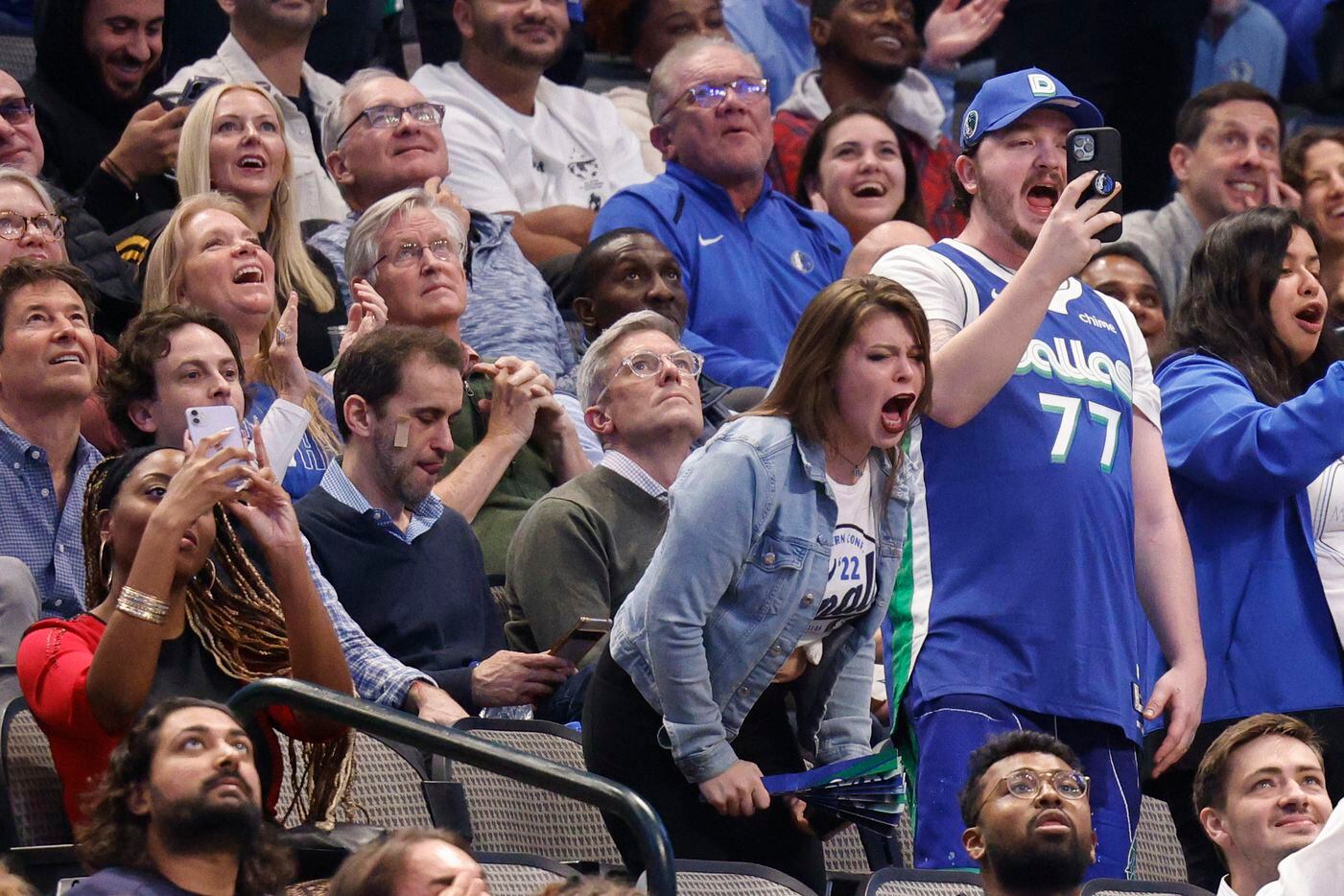Dallas Mavericks fans cheer and chant “OBJ” as NFL free agent Odell Beckham Jr. is shown...