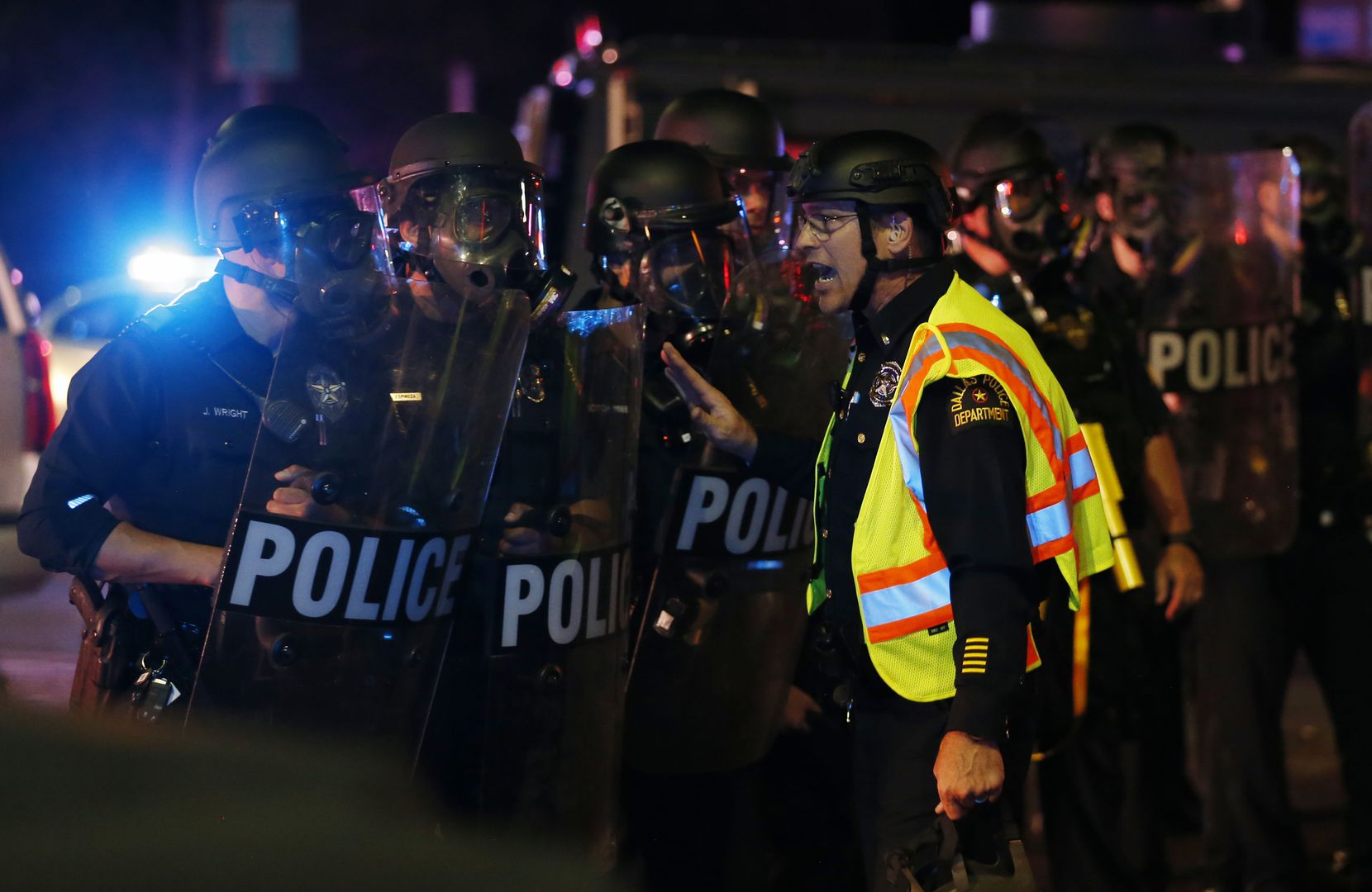Dallas police work on controlling the protesters along the intersection of Young Street and...