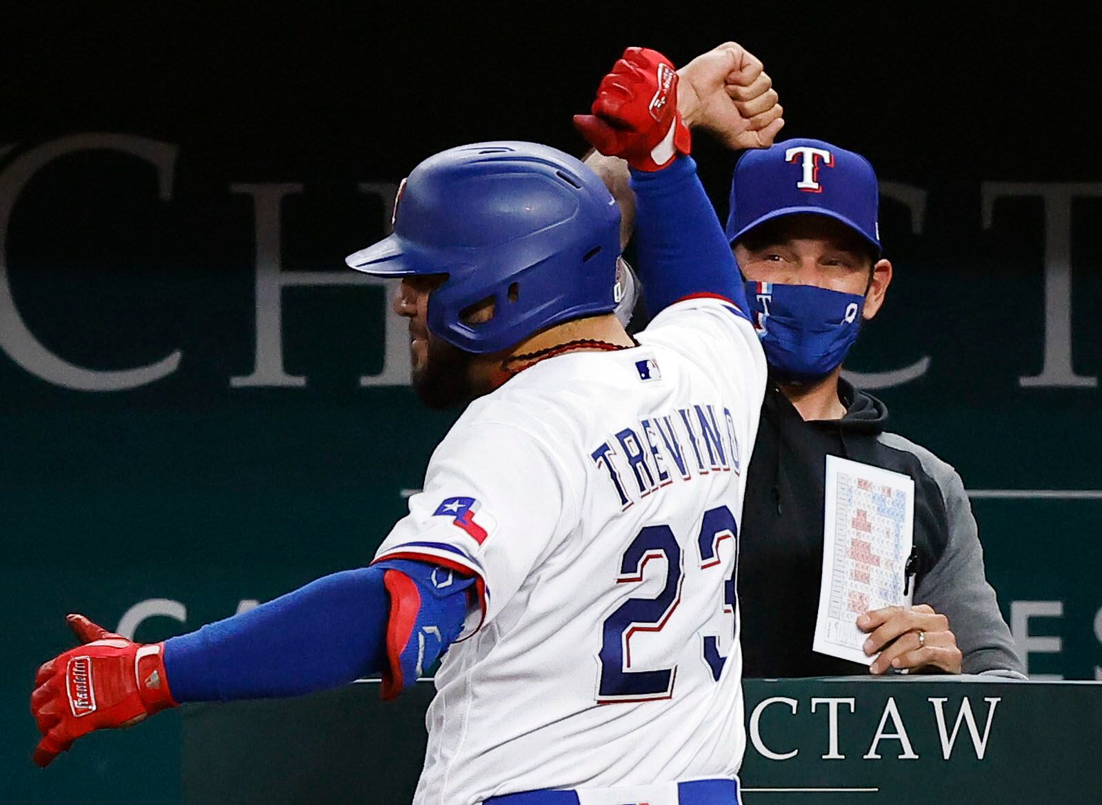 Texas Rangers Jose Trevino (23) is congratulated by manager Chris Woodward on his two-run...