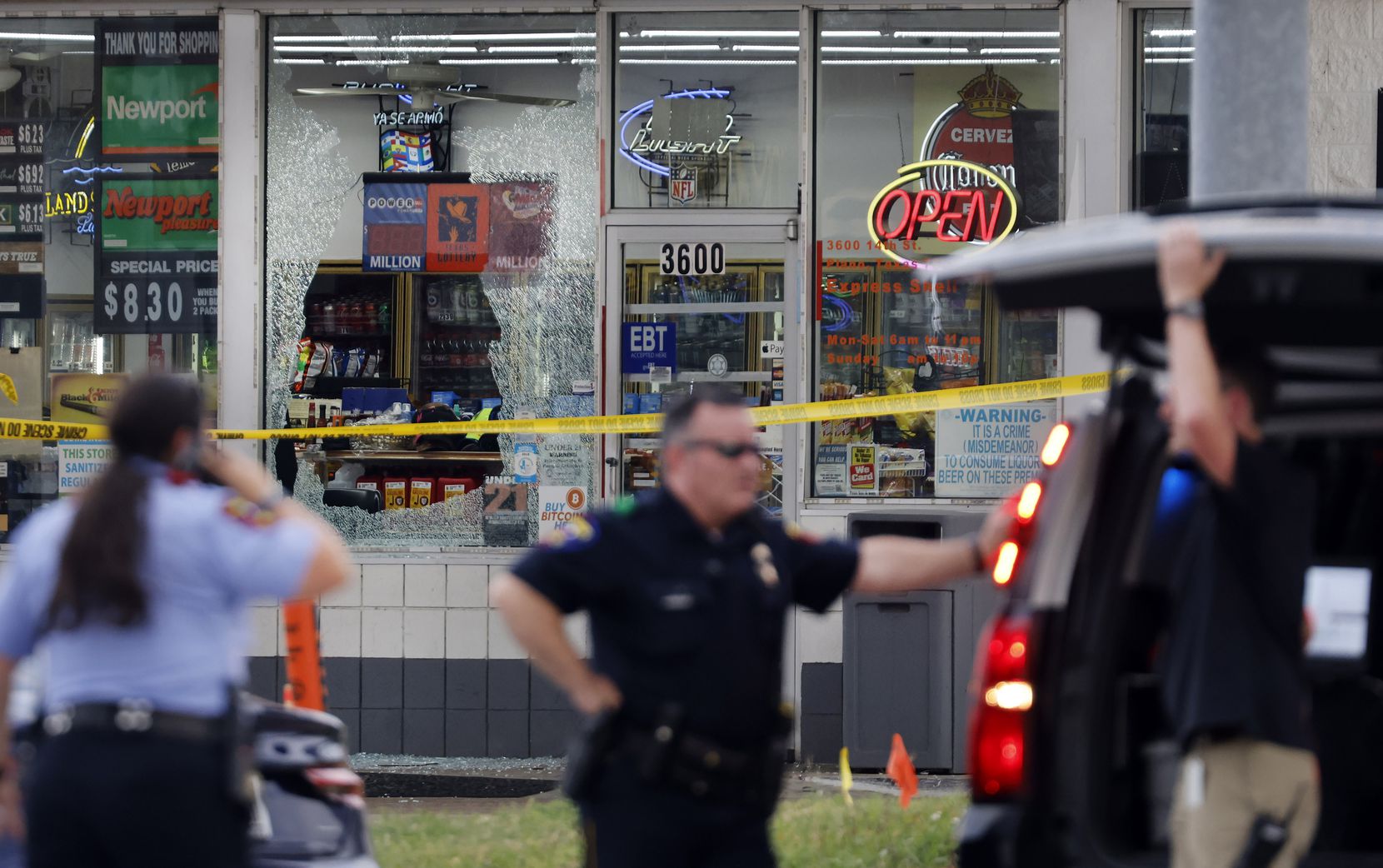 A large window is shot out at a Shell station across the street from the 7-Eleven where...