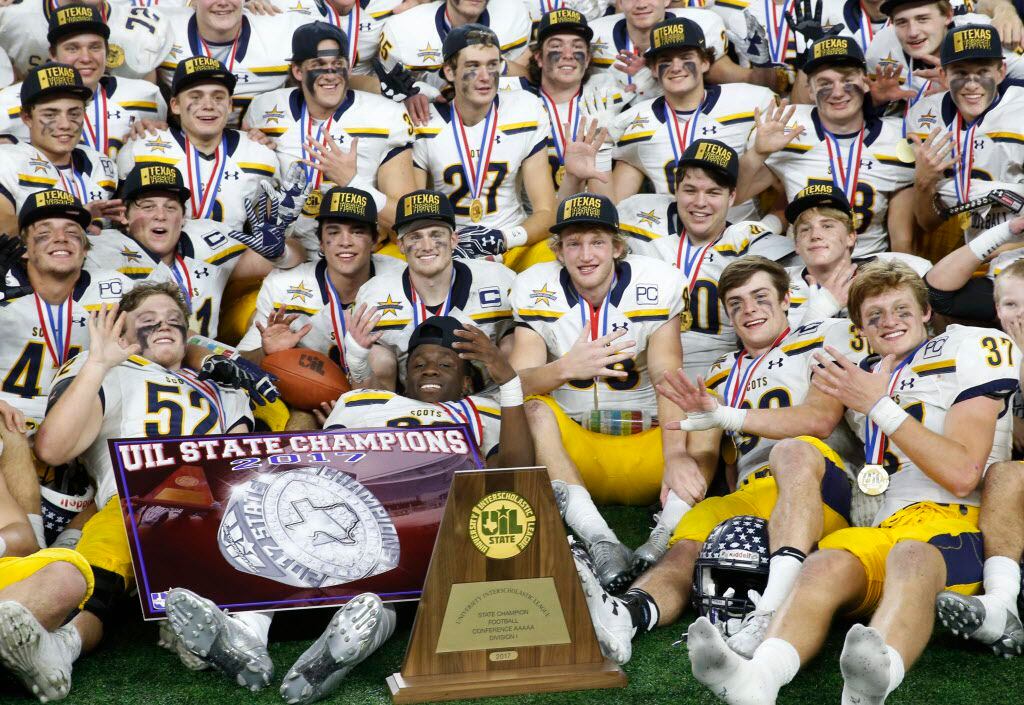 Highland Park football team poses with the trophy after defeating Manvel in the UIL Class 5A...
