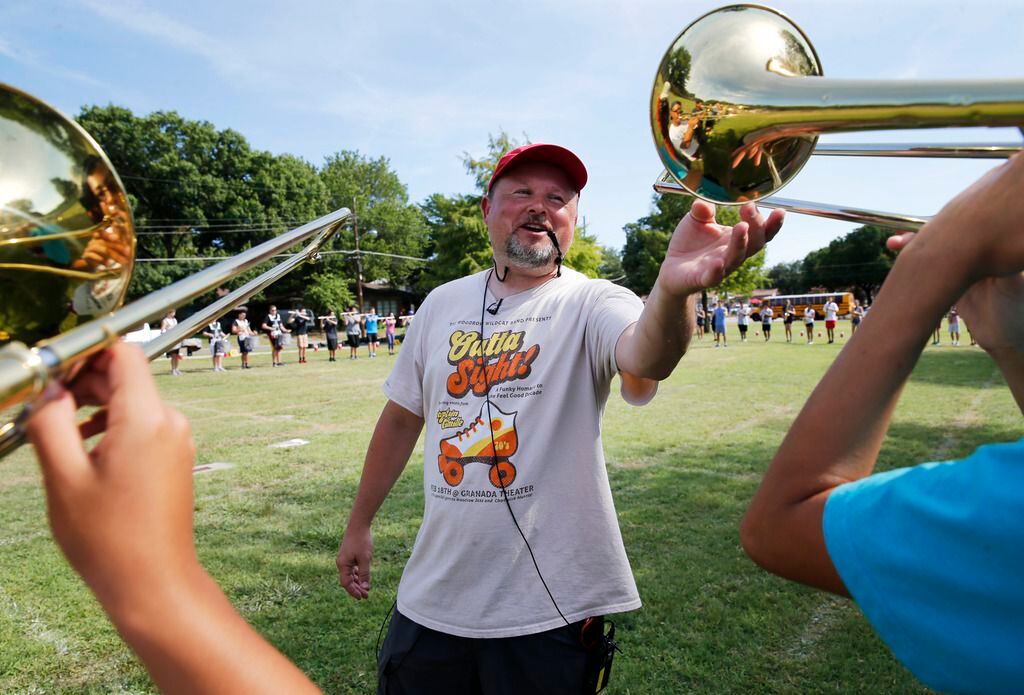 Woodrow Wilson band director Chris Evetts gets a student to raise their instrument higher...