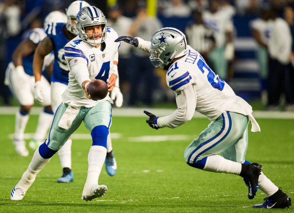 Dallas Cowboys quarterback Dak Prescott (4) hands off the ball to running back Ezekiel Elliott (21) during the second quarter of an NFL game between the Dallas Cowboys and the Indianapolis Colts on Sunday, December 16, 2018 at Lucas Oil Stadium in Indianapolis, Indiana. (Ashley Landis/The Dallas Morning News)