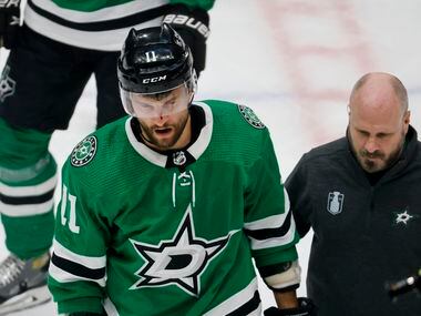 Dallas Stars center Luke Glendening (11) skates off. the ice after being hit in the nose by...