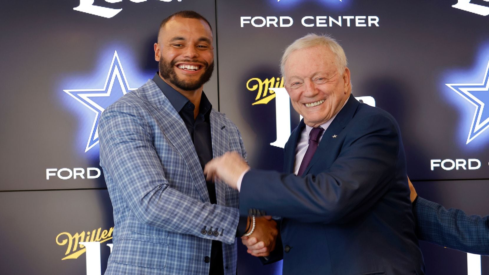 Dallas Cowboys quarterback Dak Prescott (left) and Dallas Cowboys owner Jerry Jones shake hands following a press conference at The Star in Frisco, Texas, Wednesday, March 10, 2021. Dak spoke about his freshly signed 4-year, $160 million contract with the team.