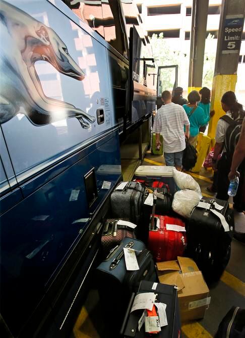 
Passengers line up for boarding. Greyhound has been overhauling its fleet with new engines...