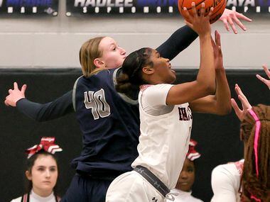 Denton Braswell guard Kennedy Evans, (right) tries to get put up a shot against Flower Mound...