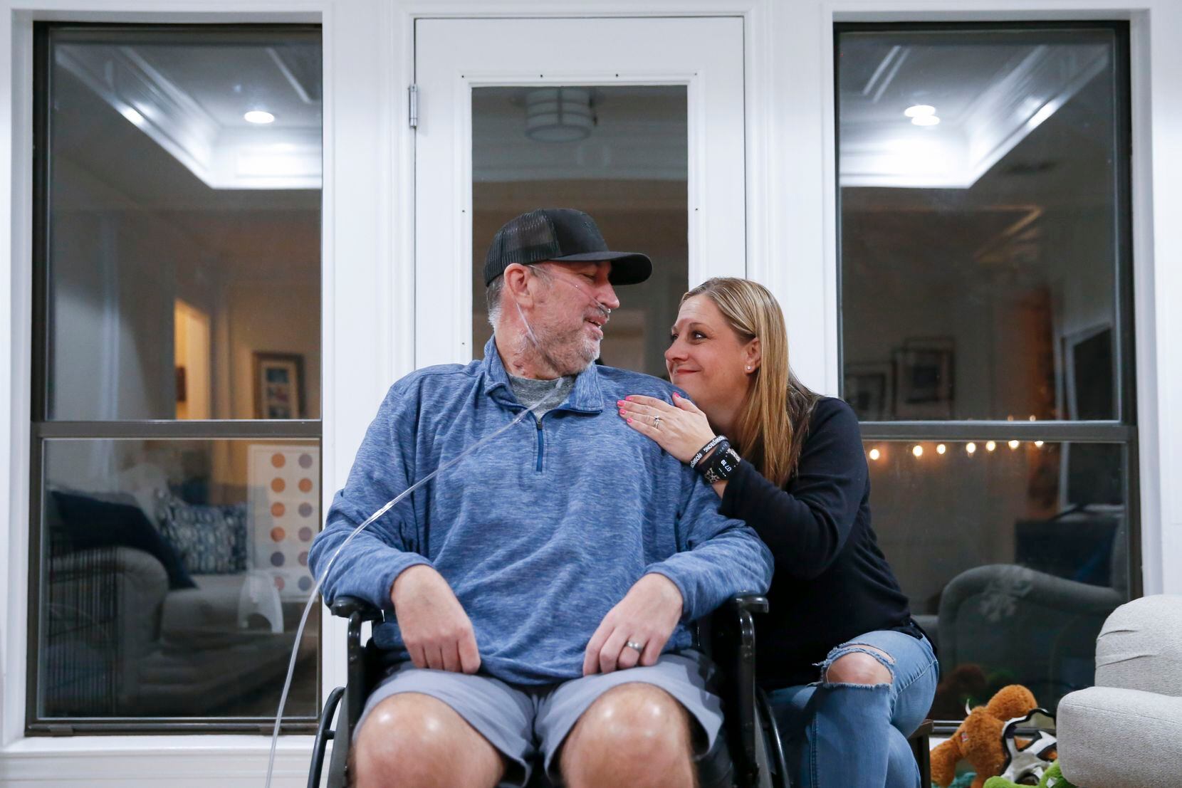 Josh and Emily share a moment at their home in Plano. He was hospitalized with COVID-19 for...