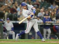 Texas Rangers' Josh Jung swings into a pitch and hits a solo home run on a pitch from...