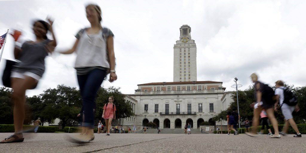 Students walk through the University of Texas at Austin campus near the school's iconic tower.