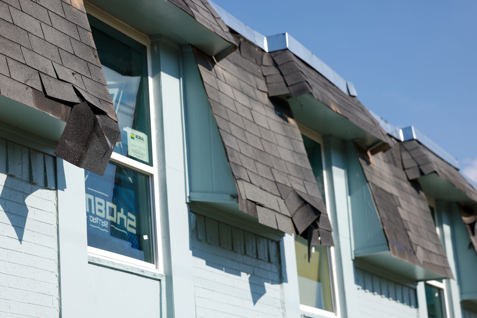 Shingles hang from the roof of Frances Place Apartments, a multi-family complex in Dallas,...
