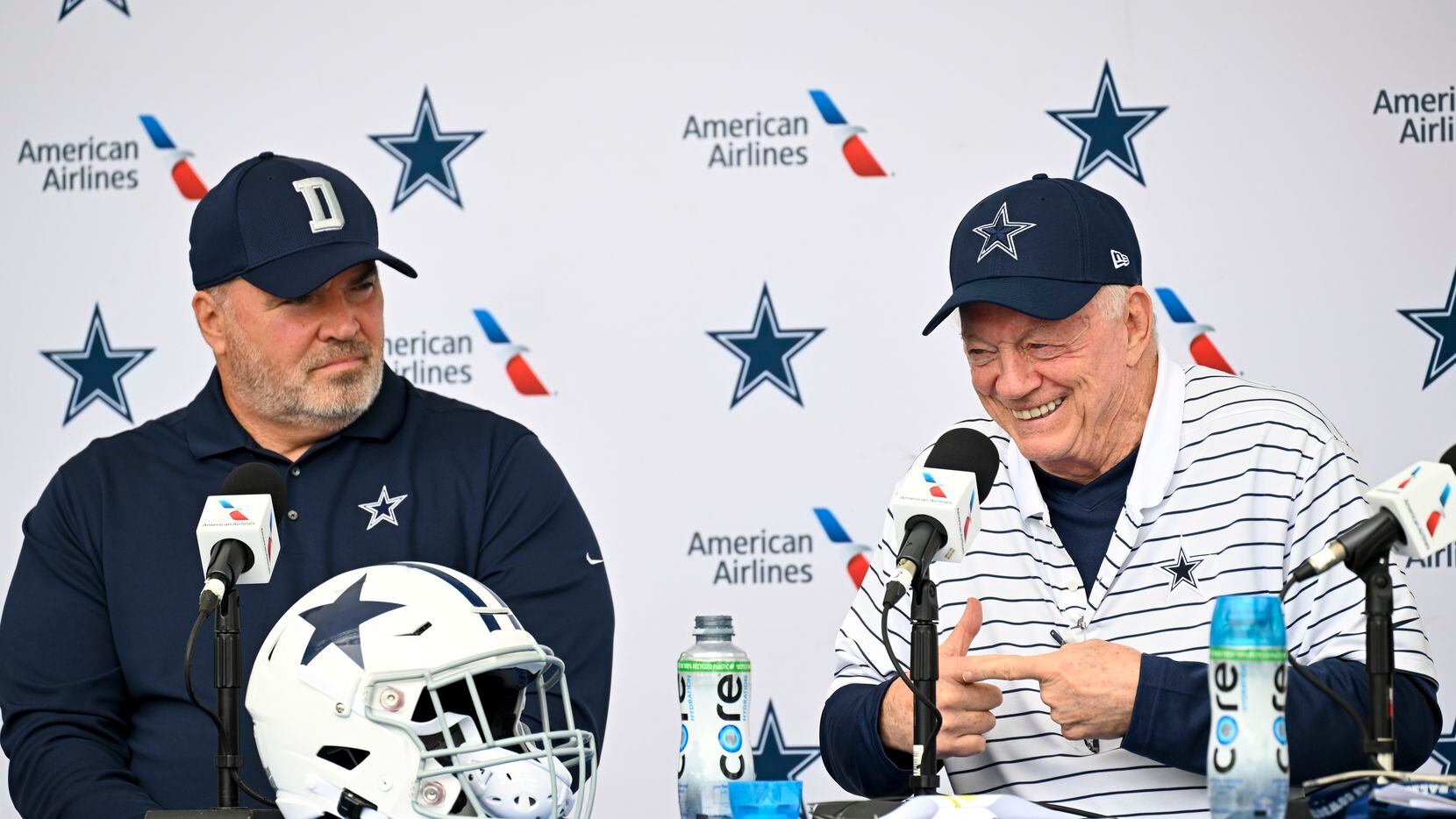 Dallas Cowboys head coach Mike McCarthy, left and owner Jerry Jones, right, react as they...