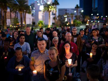 LAS VEGAS, NV - OCTOBER 2: Mourners attend a candlelight vigil at the corner of Sahara...