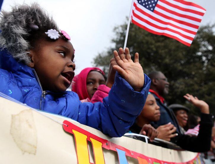 Children wave during the Martin Luther King Jr. Parade. 