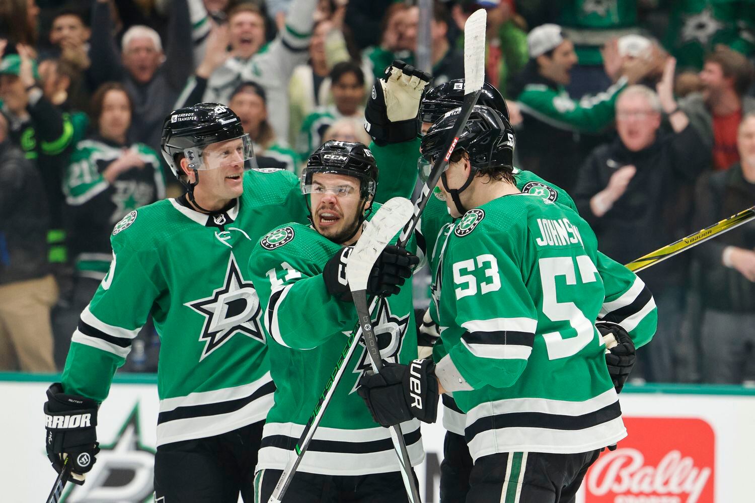 Dallas Stars players cheer following a goal by center Logan Stankoven (center) during the...