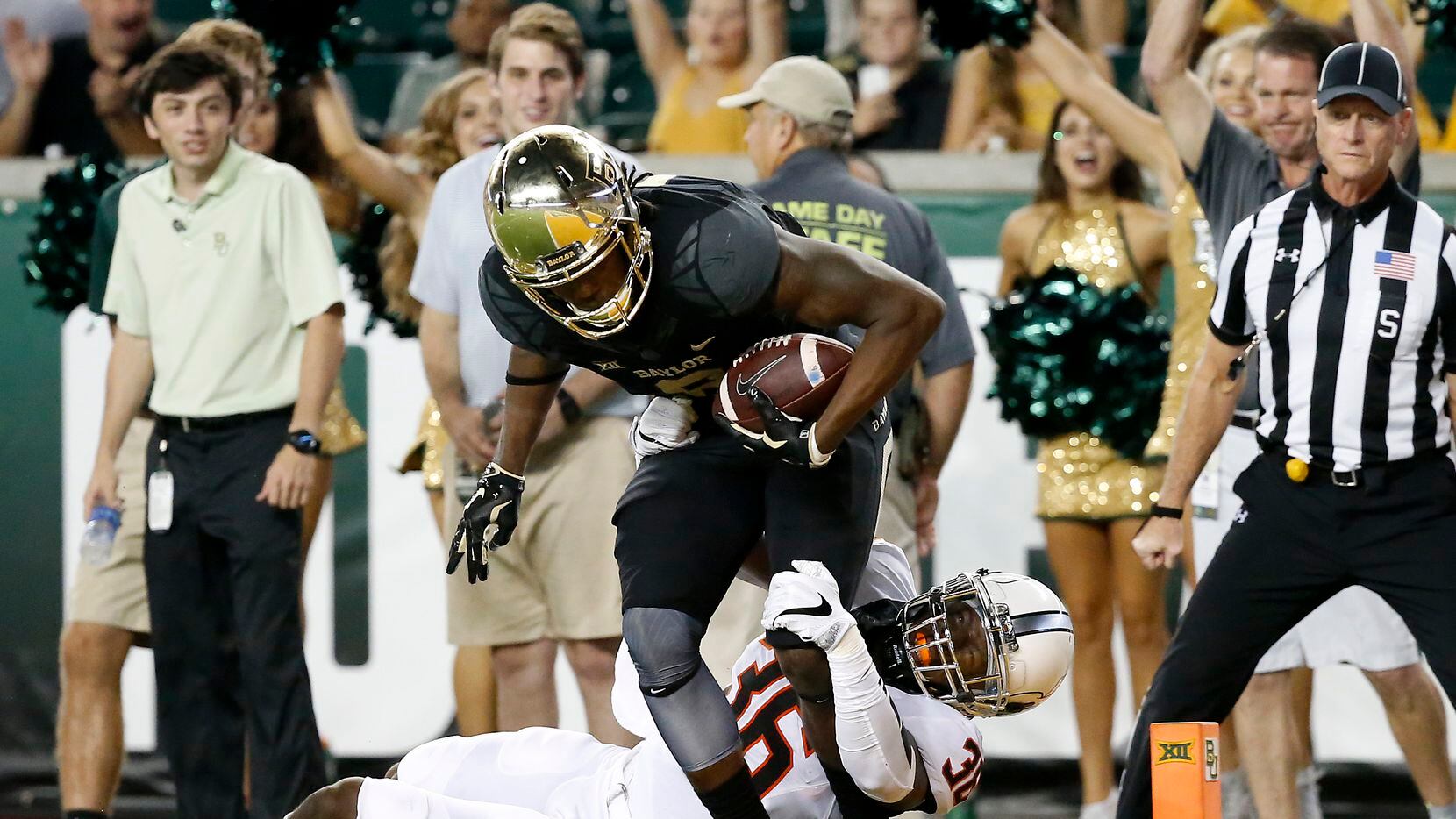 Baylor wide receiver Ishmael Zamora (8) powers past Oklahoma State safety Derrick Moncrief...