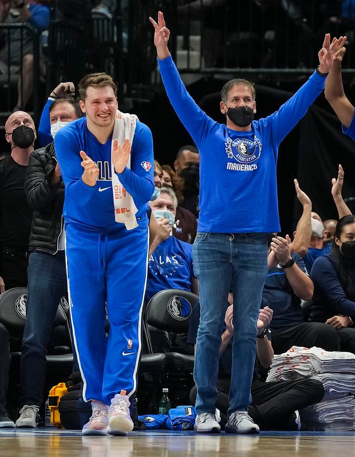 Dallas Mavericks guard Luka Doncic and owner Mark Cuban celebrate a 3-pointer during the...
