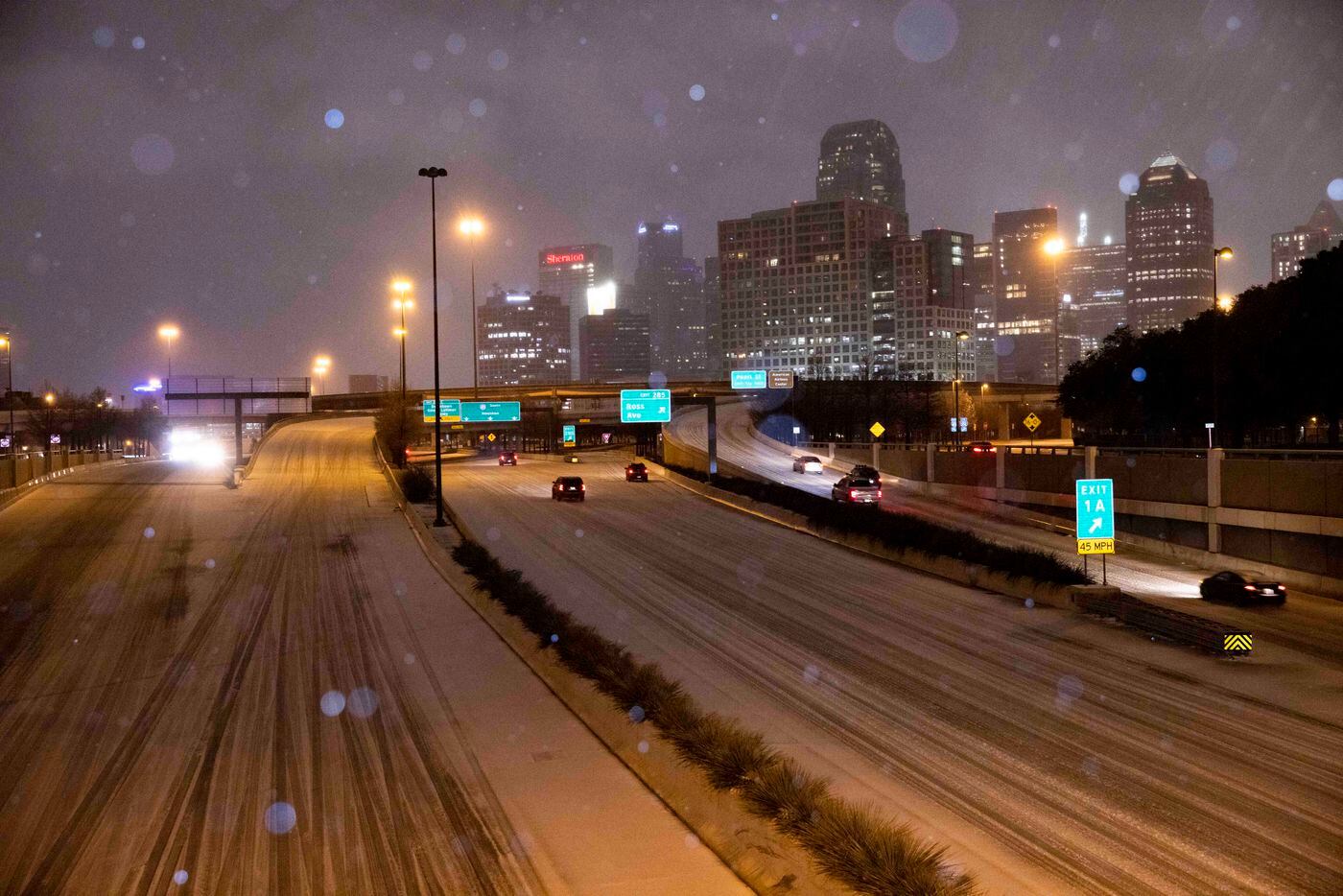 Vehicles drive on North Central Expressway as sleet falls on Thursday, Feb. 3, 2022, in...