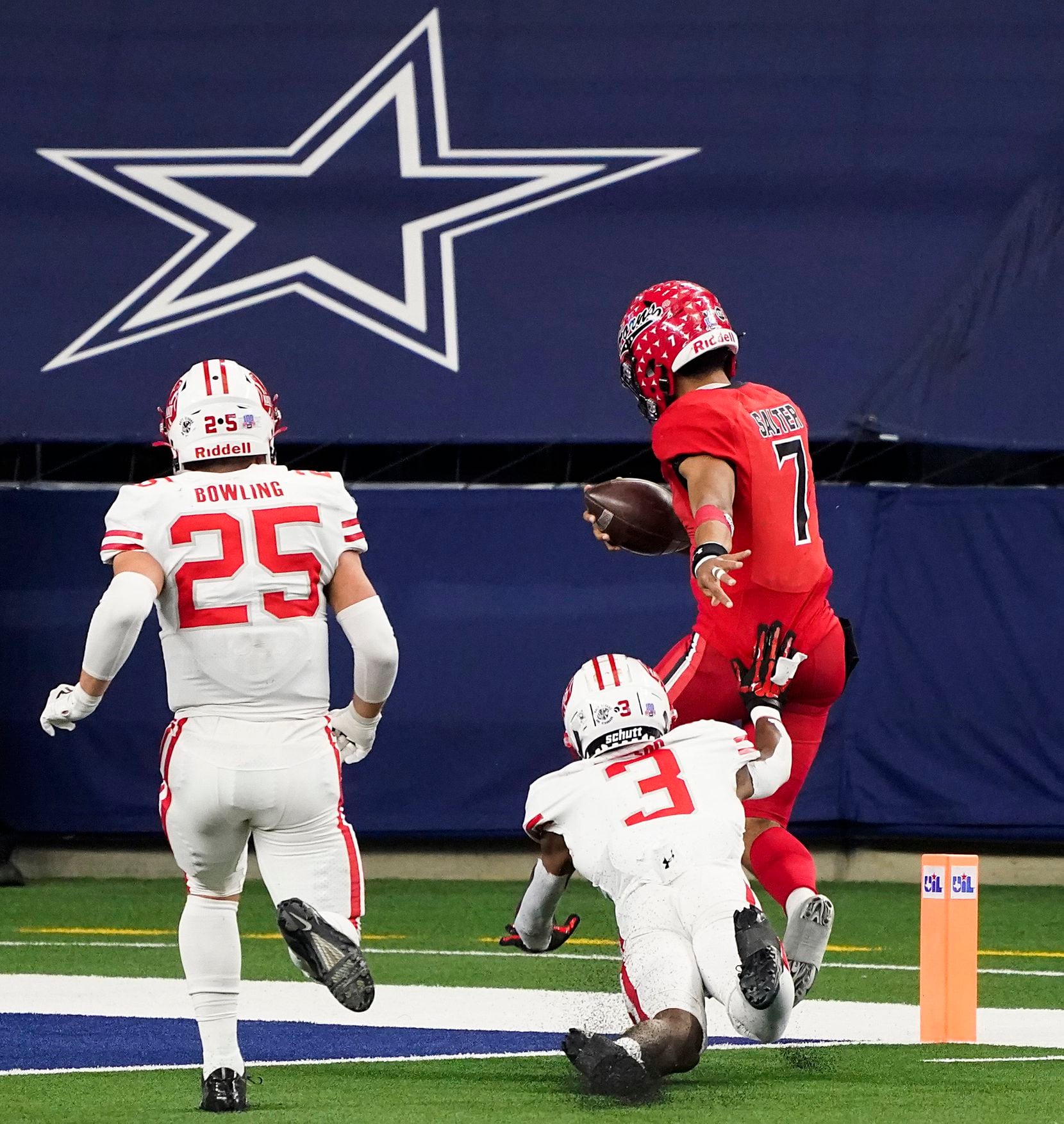 Cedar Hill quarterback Kaidon Salter (7) gets past Katy defensive back Bobby Taylor (3) and Shepherd Bowling (25) for a 10-yard touchdown during the second half of the Class 6A Division II state football championship game at AT&T Stadium on Saturday, Jan. 16, 2021, in Arlington, Texas. Katy won the game 51-14.