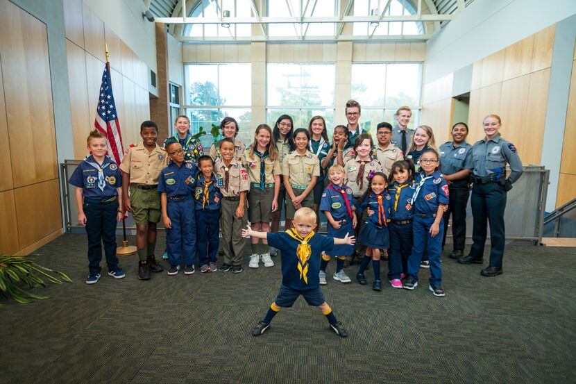 A group of Scouts across a range of ages pose for a photo together.