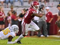 Oklahoma wide receiver Theo Wease (10) avoids a tackle by Kent State defensive back D.J....